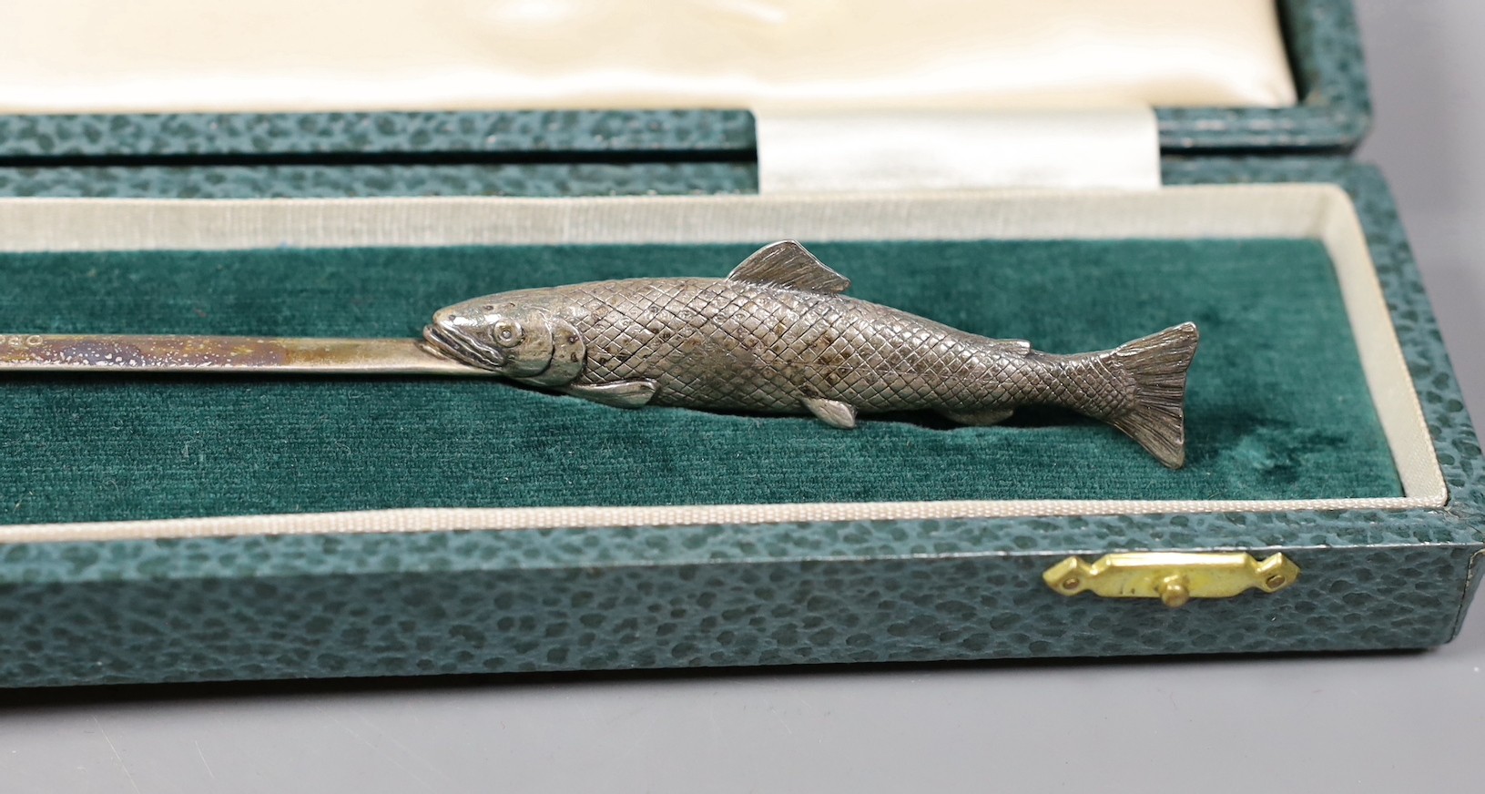 A late Victorian engraved silver christening trio, Wakely & Wheeler, London, 1889/90, a cased novelty silver letter opener, with fish handle, C.J. Vander Ltd, London, 1971 and a cased pair of silver plated fish servers.